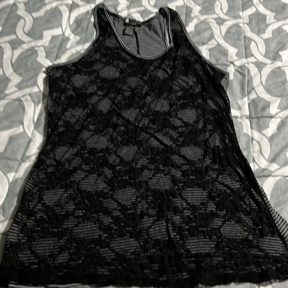 Woman’s sleeveless shirt with black lace in the front and stripe black and grey